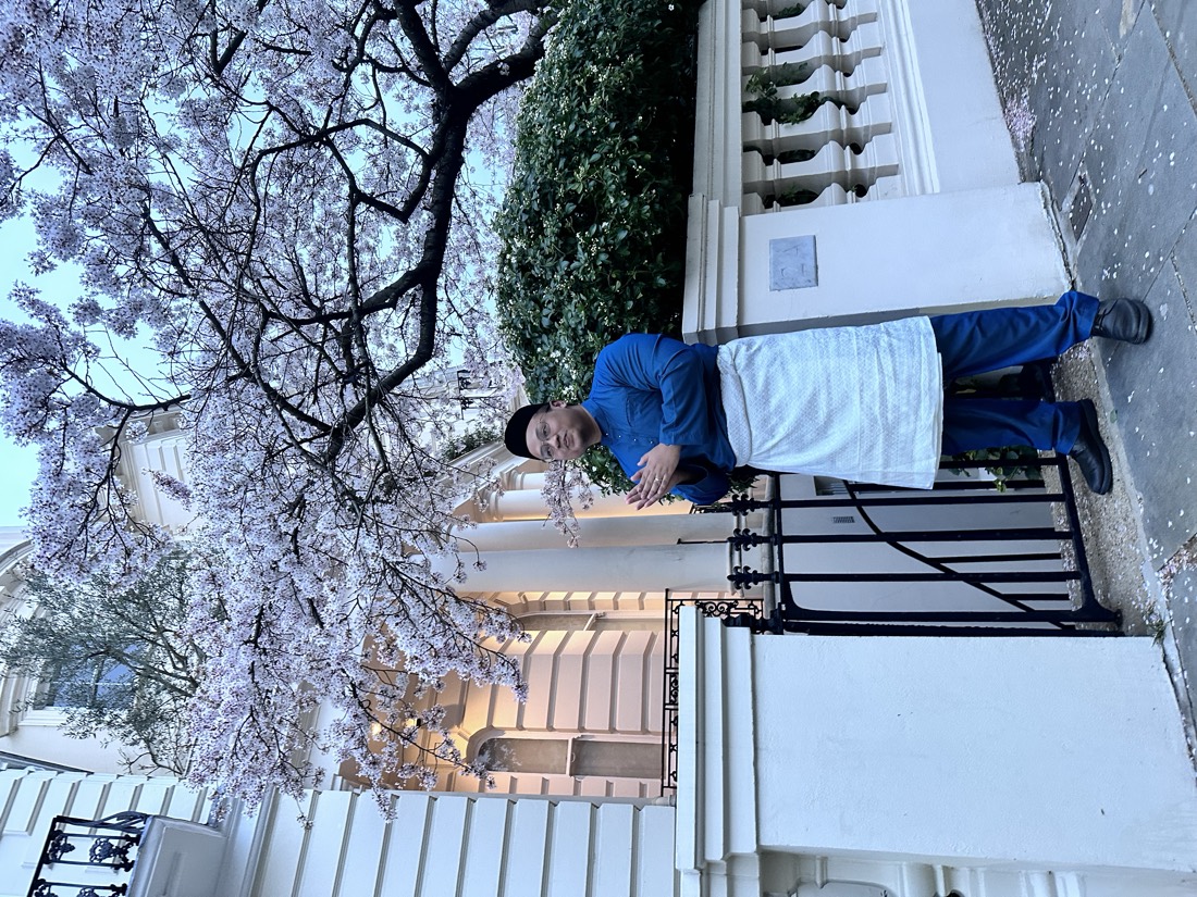 Hafiz in baju melayu under cherry blossoms in London on Hari Raya